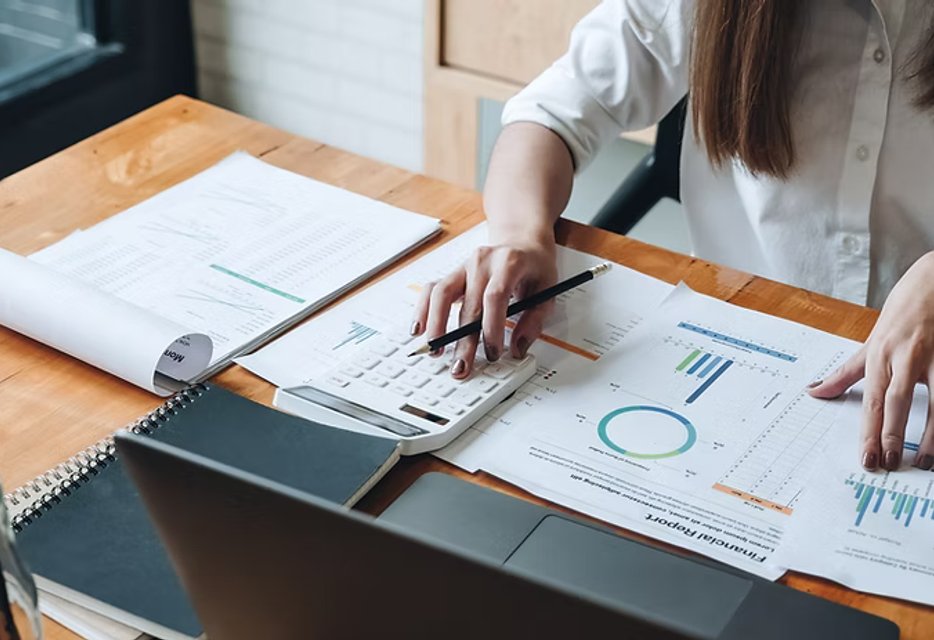 various financial reports and tools on a table