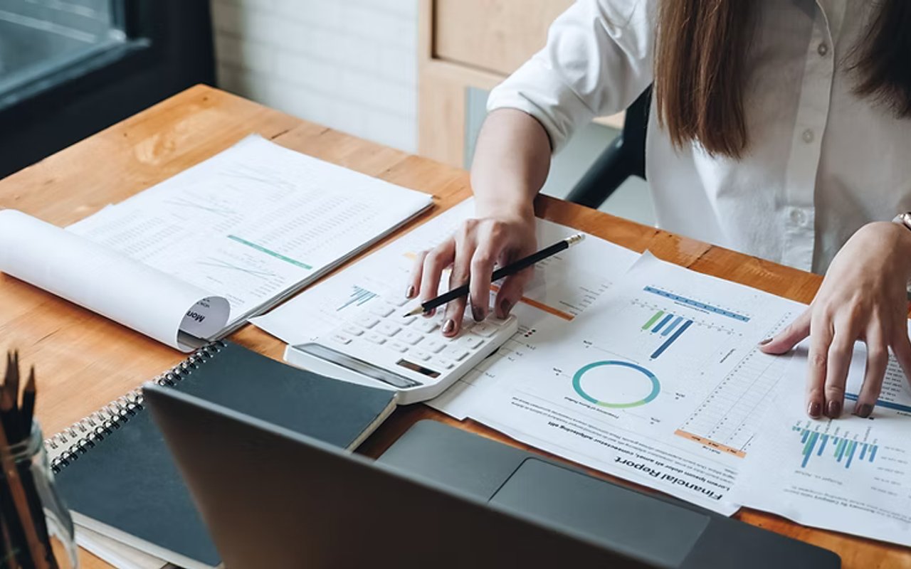 various financial reports and tools on a table