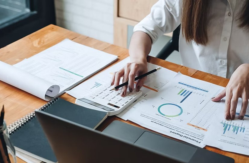 various financial reports and tools on a table